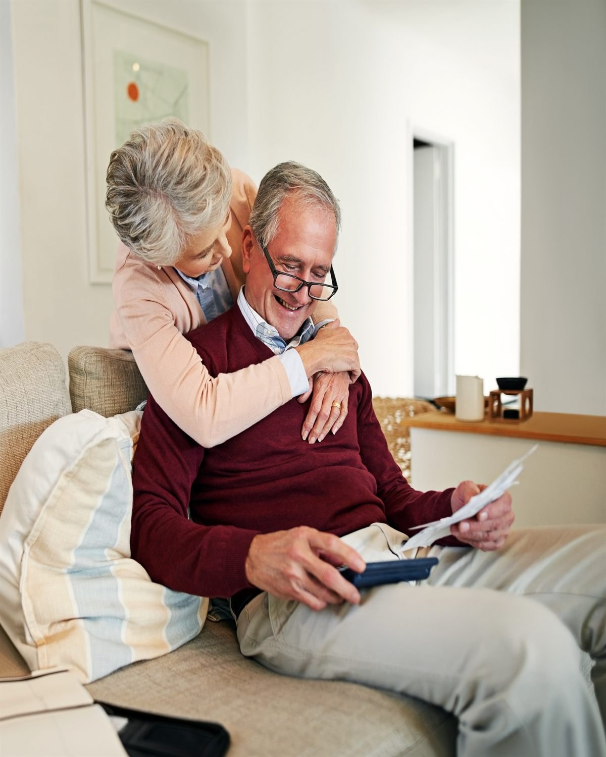 A senior couple reviewing paperwork together at home